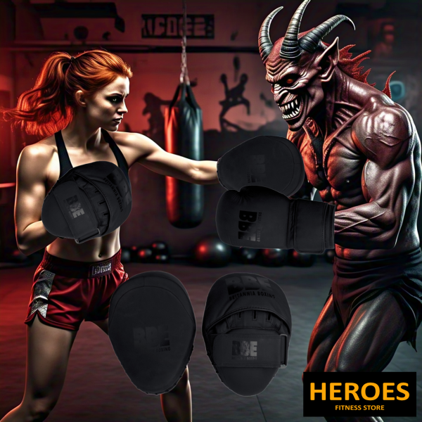 A woman and Demon in boxing gloves stand confidently, showcasing strength and bbe matte black focus pads nearby.