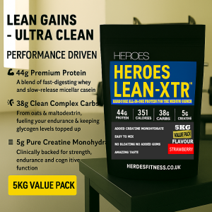 Heroes LEAN-XTR™ 5kg value pack lean muscle strawberry protein powder with whey, casein, creatine, and clean carbs – ultra-clean all-in-one supplement for strength, endurance, and performance, displayed on gym bench with modern fitness background