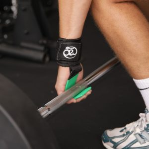 Fitness Mad Heavy Duty Lifting Hooks being used to lift a barbell in a gym