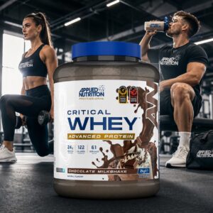 Applied Nutrition Critical Whey Chocolate Milkshake 2kg protein powder in a modern gym setting with male and female athletes training, featuring an athlete drinking a chocolate protein shake from an Applied Nutrition shaker.